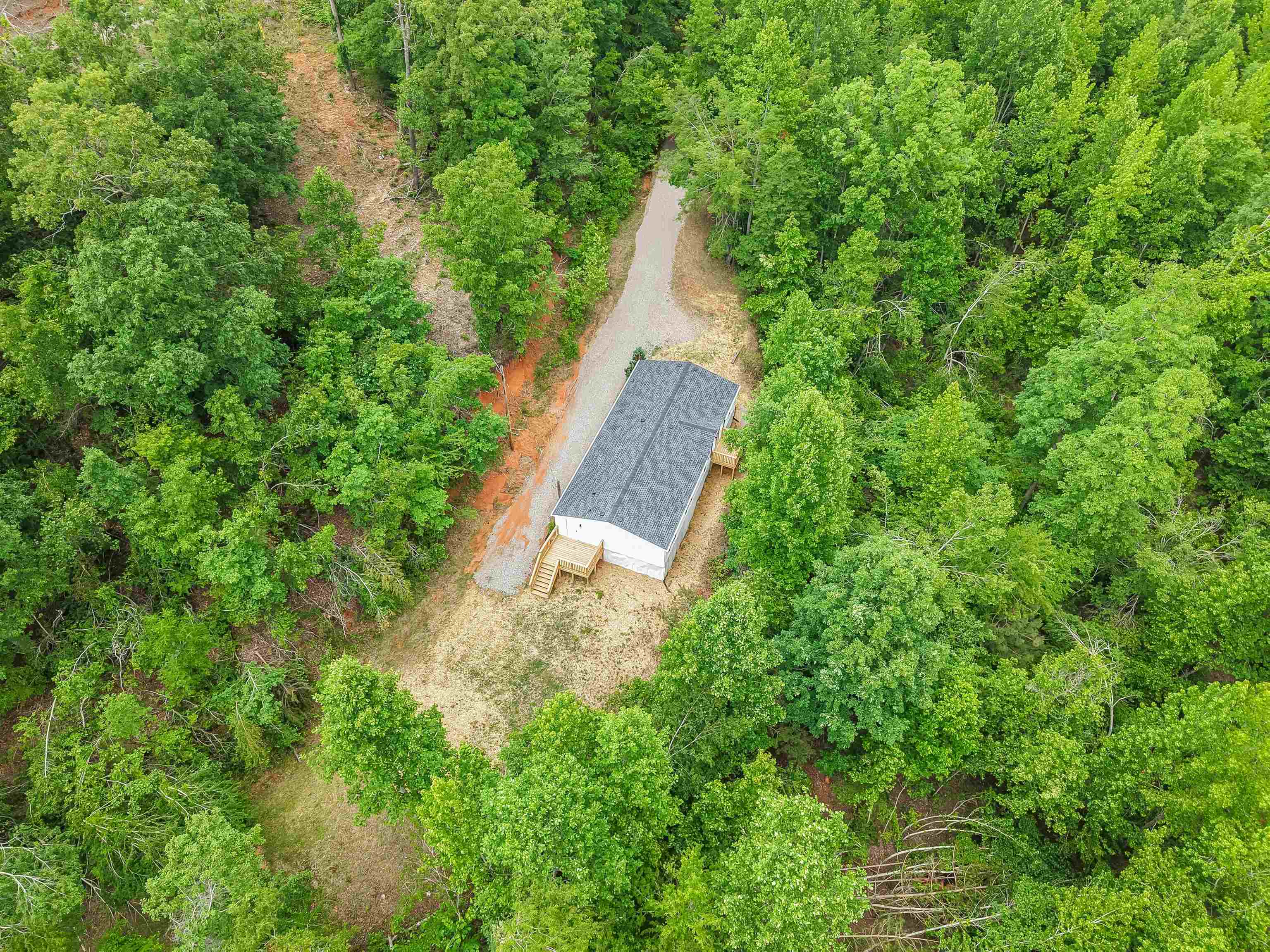 890 Burks Road Savannah, TN 38372 - Photo 33 of 40 an aerial view of a house with a yard and large trees