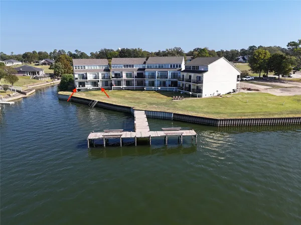 a view of a lake with a building and outdoor seating