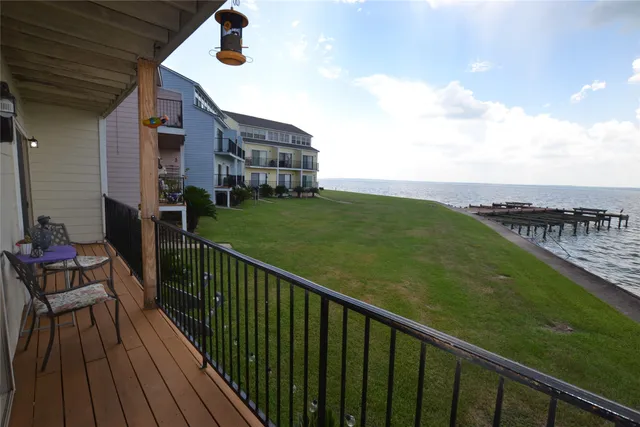 a view of a dining room with furniture a chandelier and wooden floor