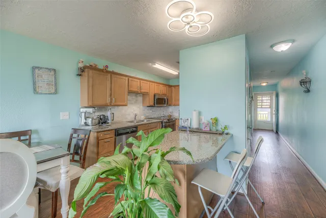 a spacious bedroom with a bed and a chandelier
