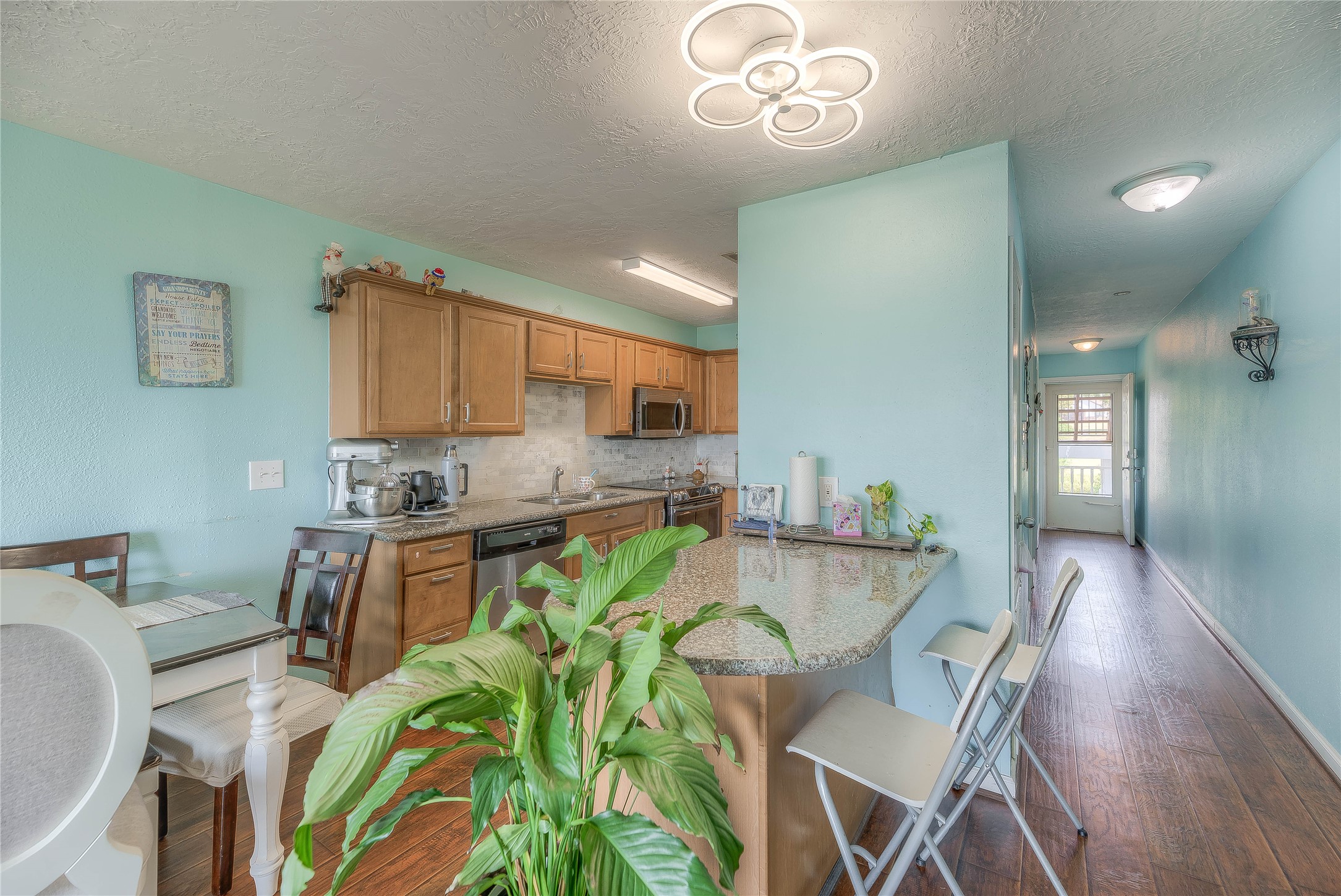 445 Carolcrest Lane, Unit 112 Livingston, TX 77351 - Photo 15 of 33 a view of a dining room with furniture a chandelier and wooden floor