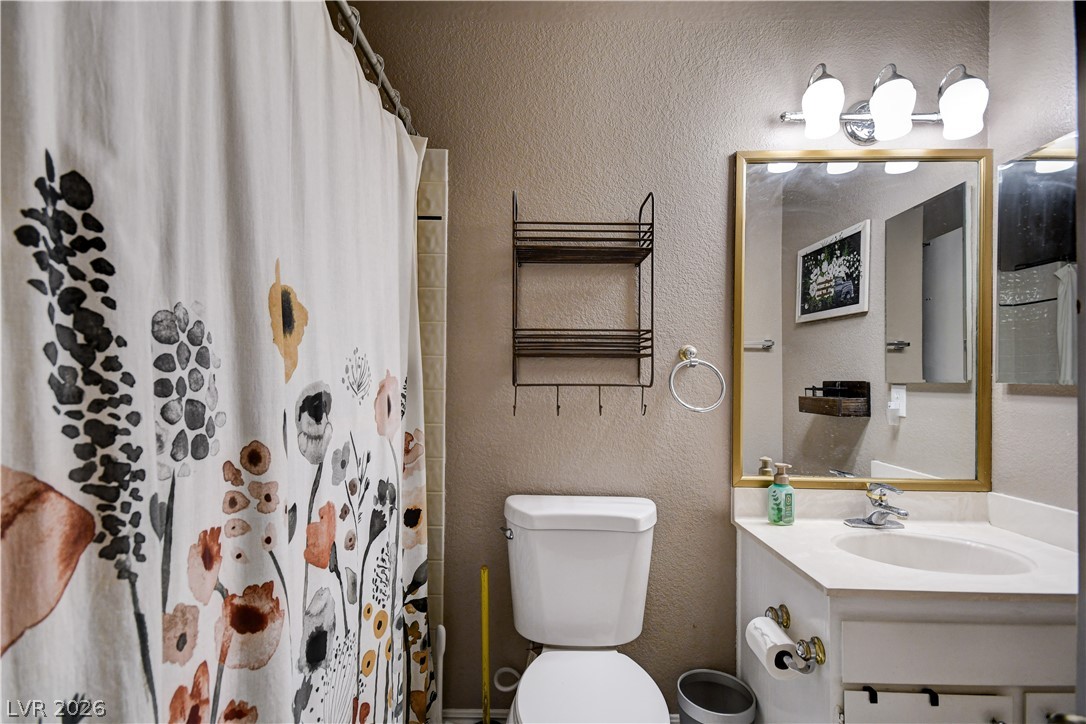 659 Arrayo Way Boulder City, NV 89005 - Photo 16 of 29 A classic vanity mirror and clean white countertop define this functional bathroom space.
