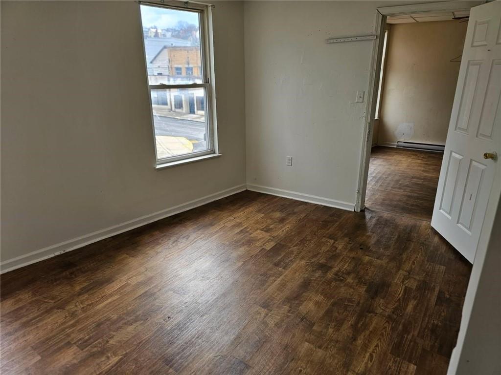 300 Longfellow Street Vandergrift, PA 15690 - Photo 11 of 34 an empty room with wooden floor and windows
