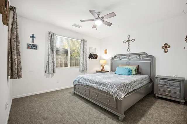 a spacious bedroom with a bed and window