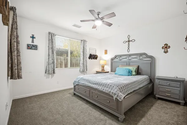 a spacious bedroom with a bed and window