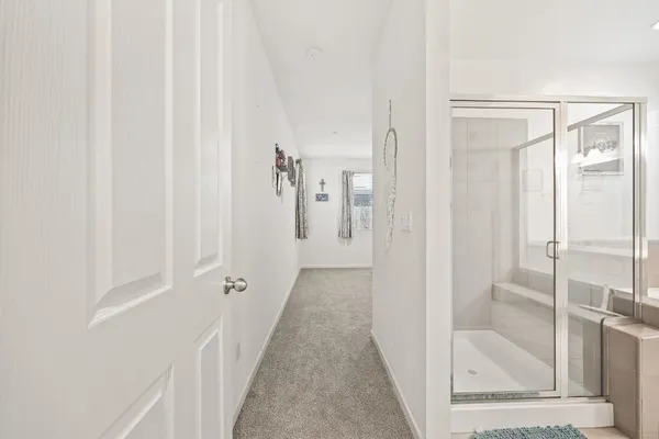 a view of a bathroom from a hallway