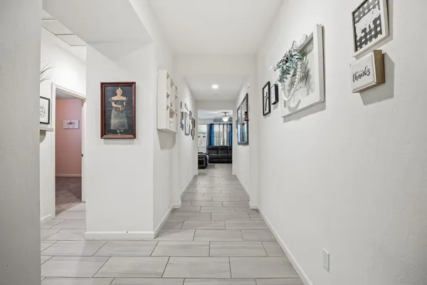 a view of a hallway with seating area