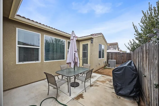 a view of a house with backyard and sitting area