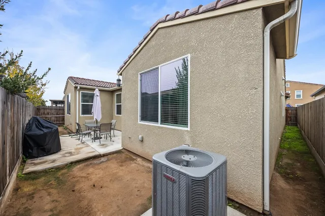a front view of a house with outdoor seating