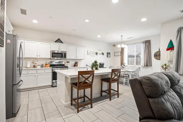 a kitchen with cabinets and chairs in it