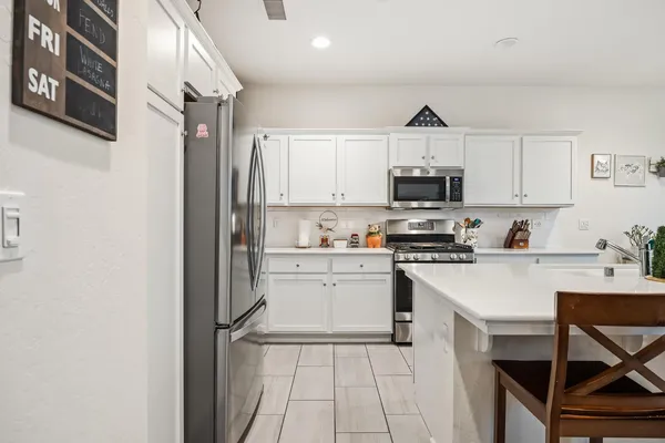a kitchen with a white cabinets and white appliances