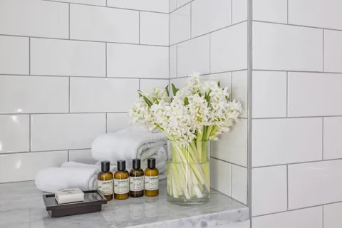 a vase of flowers sitting on a shelf
