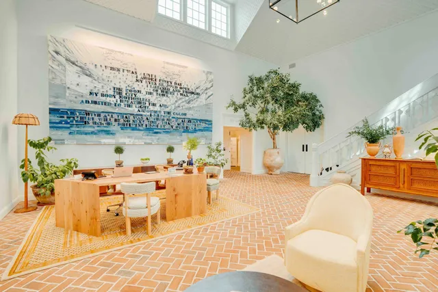 a living room with furniture a chandelier and a table