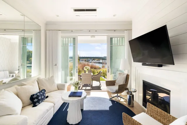 a living room with furniture a fireplace and a flat screen tv