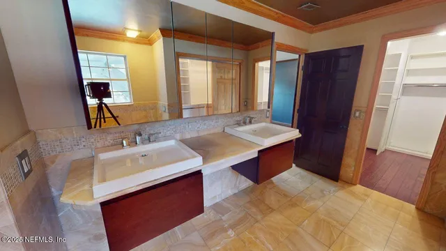 an empty room with wooden floor and a ceiling fan