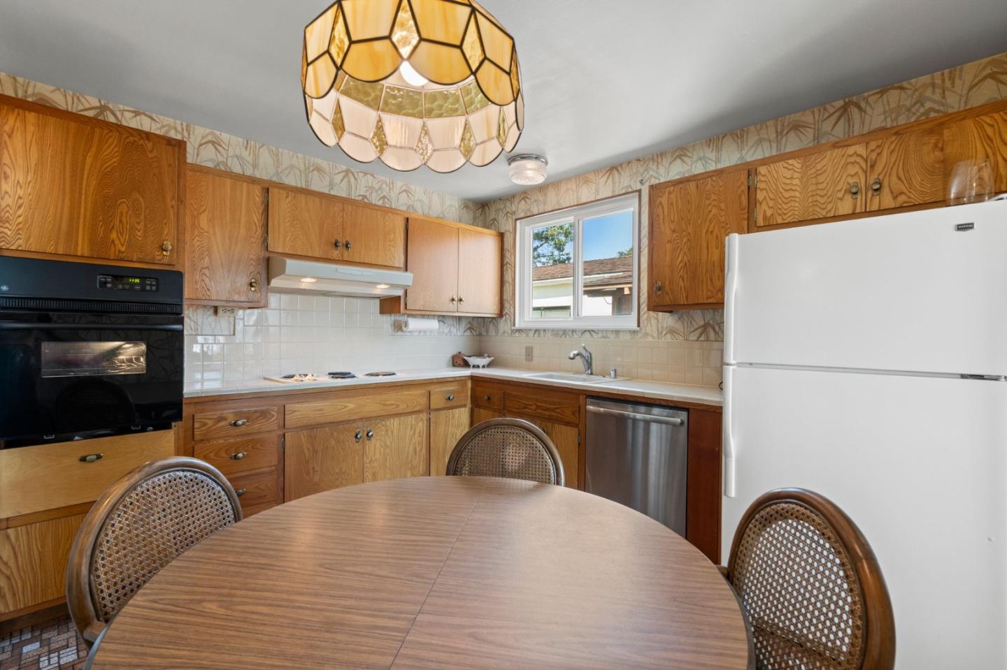 430 Higate Drive Daly City, CA 94015 - Photo 18 of 40 a kitchen with stainless steel appliances granite countertop a sink a stove cabinets dining table and chairs
