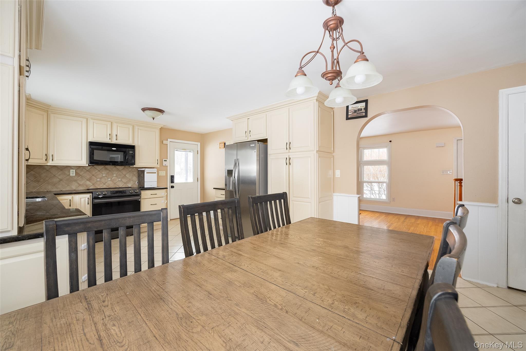 12 Valley View Road Hyde Park, NY 12538 - Photo 8 of 31 a kitchen with stainless steel appliances granite countertop a stove top oven a sink dishwasher a dining table and chairs with wooden floor