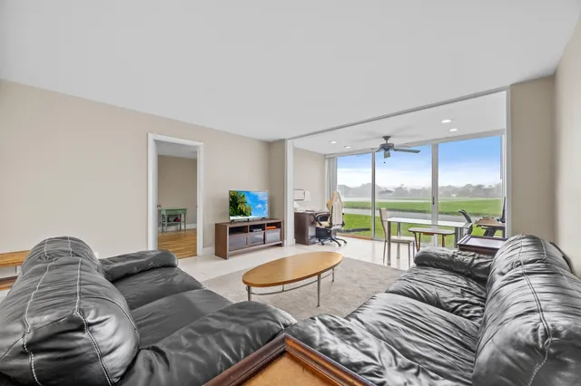 a living room with furniture and a large window