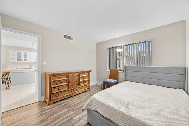 a bedroom with a bed and a dresser