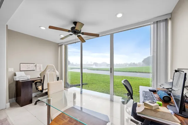 a view of a workspace with furniture and a window