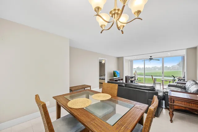 a living room with furniture a window and a table