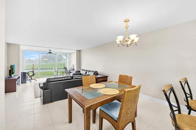 a dining room with furniture and a large window