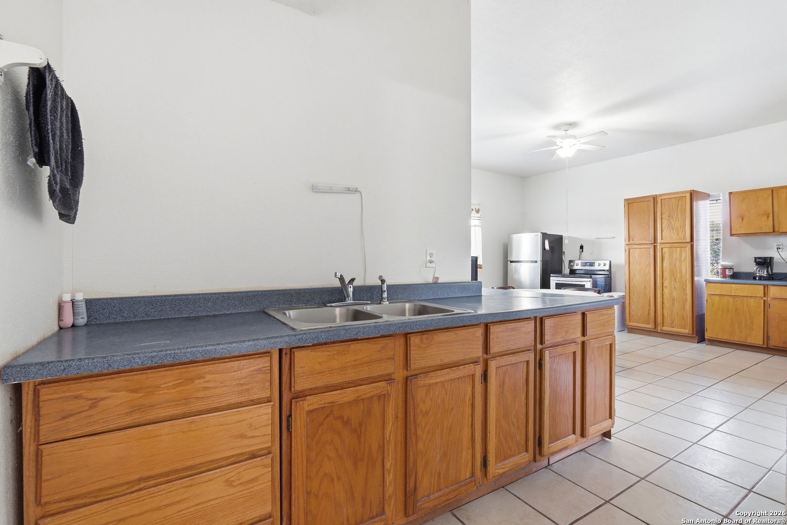 483 Sassman Road Marion, TX 78124 - Photo 13 of 39 a kitchen with stainless steel appliances granite countertop a sink and a refrigerator