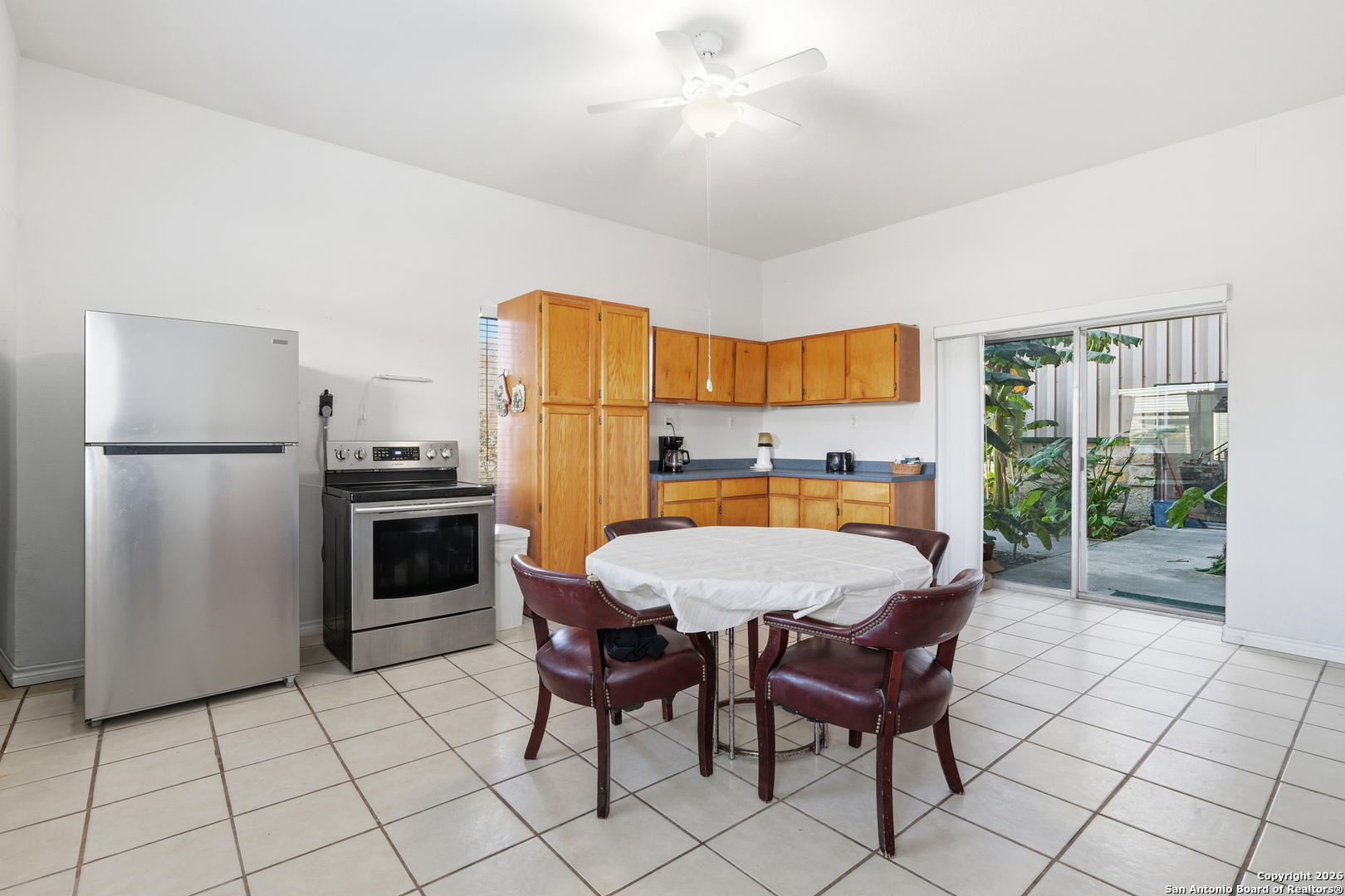 483 Sassman Road Marion, TX 78124 - Photo 15 of 39 a large kitchen with a table chairs and a refrigerator
