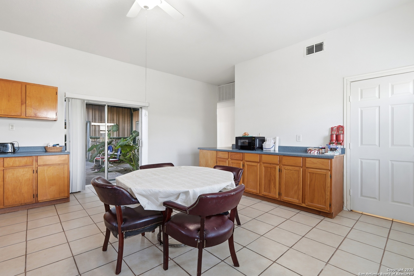 483 Sassman Road Marion, TX 78124 - Photo 16 of 39 a open kitchen with a sink dining table and chairs