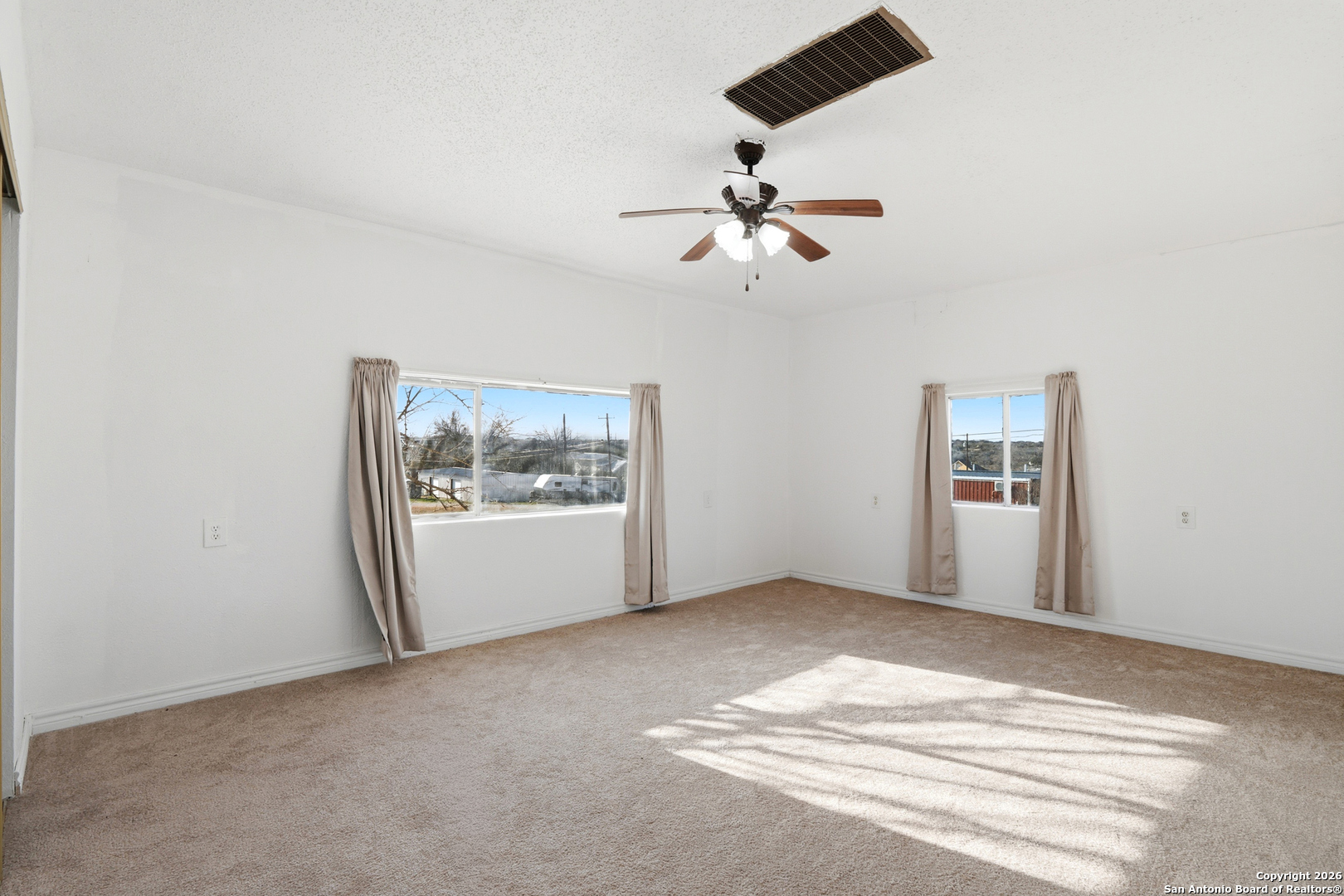 483 Sassman Road Marion, TX 78124 - Photo 25 of 39 a view of a big room with windows and ceiling fan