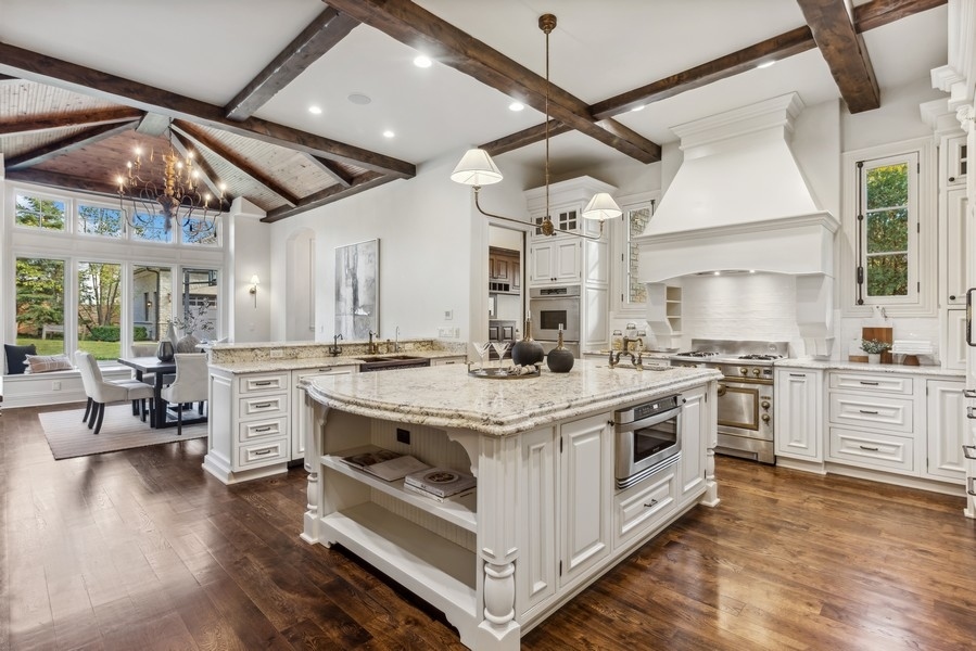 927 Cleveland Road Hinsdale, IL 60521 - Photo 12 of 46 a kitchen with stainless steel appliances granite countertop a stove and cabinets