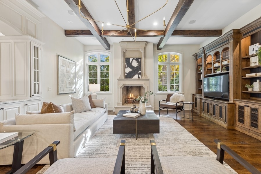 927 Cleveland Road Hinsdale, IL 60521 - Photo 18 of 46 a living room with furniture a fireplace and a flat screen tv