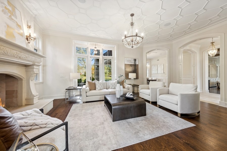 927 Cleveland Road Hinsdale, IL 60521 - Photo 2 of 46 a living room with furniture chandelier and a fireplace