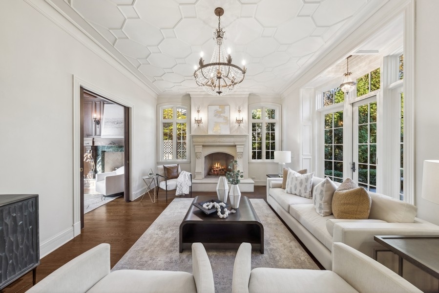 927 Cleveland Road Hinsdale, IL 60521 - Photo 3 of 46 a living room with furniture a fireplace and a chandelier