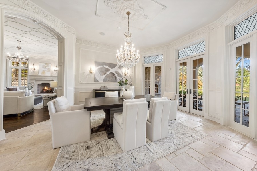 927 Cleveland Road Hinsdale, IL 60521 - Photo 8 of 46 a living room with couches a table and chairs with wooden floor