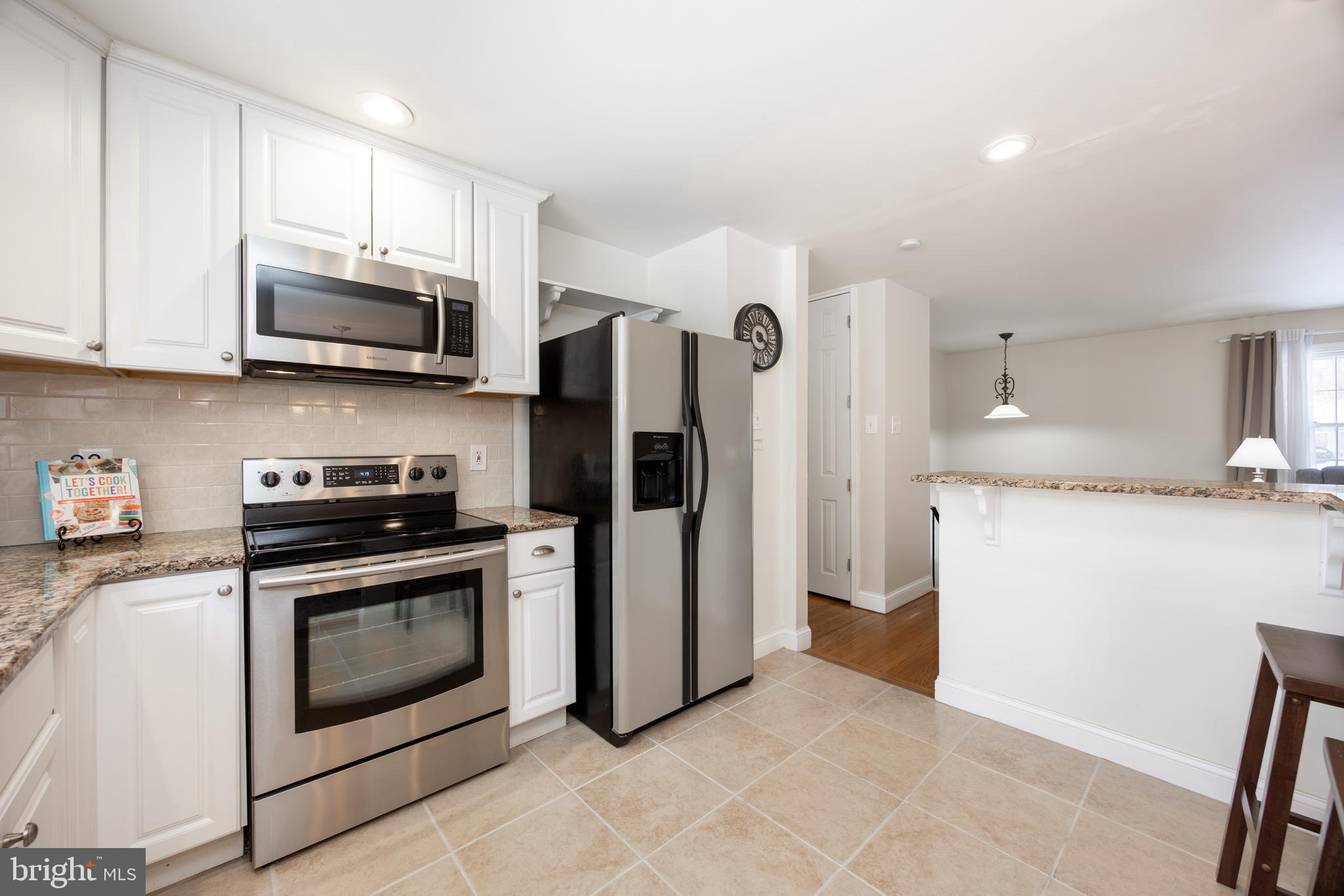 305 Concord Avenue Exton, PA 19341 - Photo 11 of 38 a kitchen with stainless steel appliances granite countertop a stove a refrigerator and a microwave