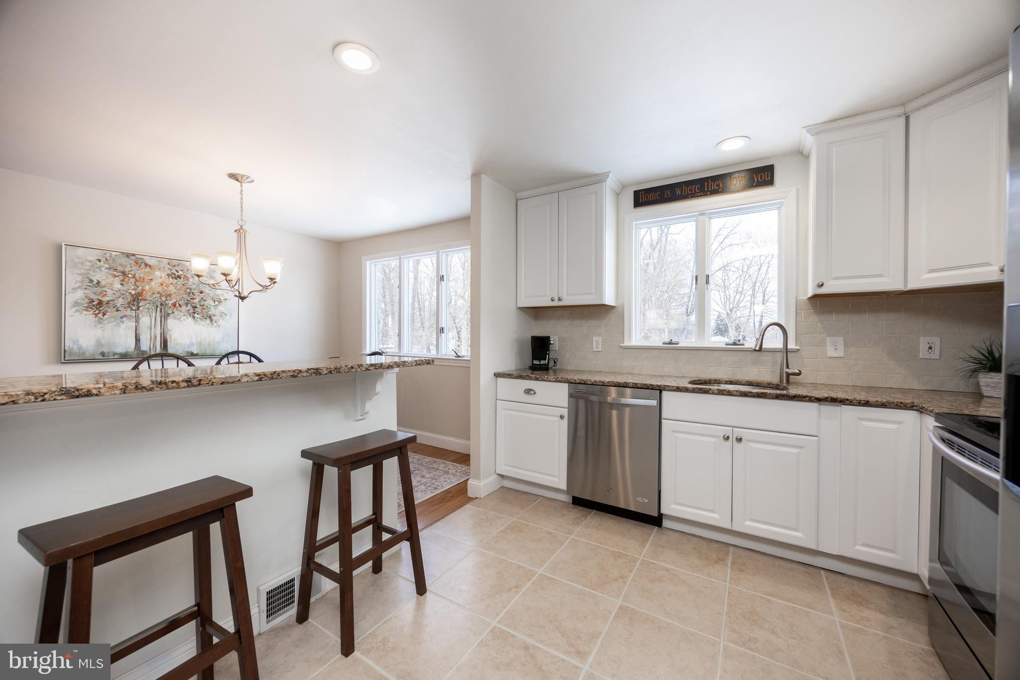 305 Concord Avenue Exton, PA 19341 - Photo 12 of 38 a kitchen with granite countertop white cabinets refrigerator and microwave