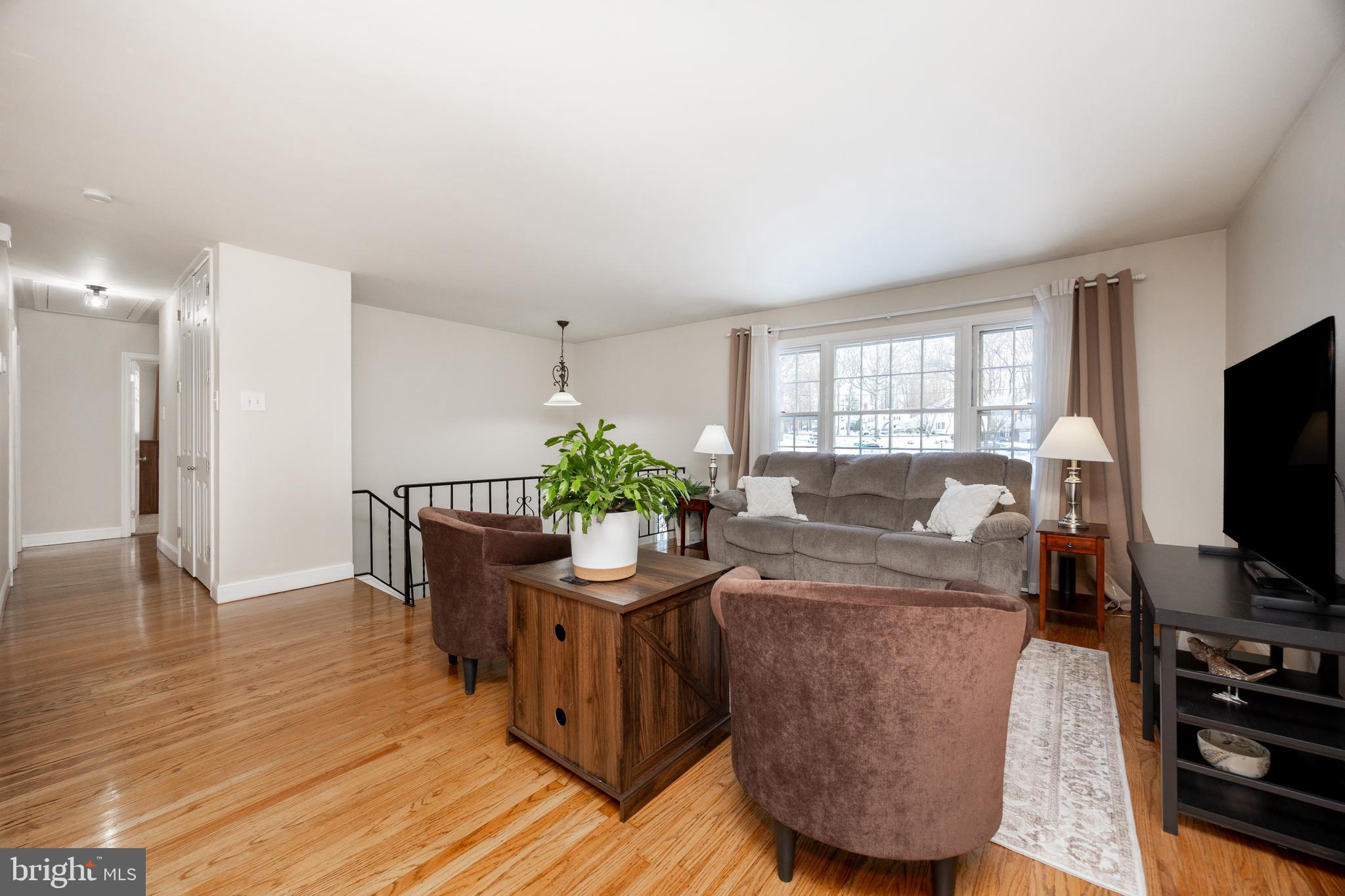305 Concord Avenue Exton, PA 19341 - Photo 14 of 38 a living room with furniture a flat screen tv and a dining table