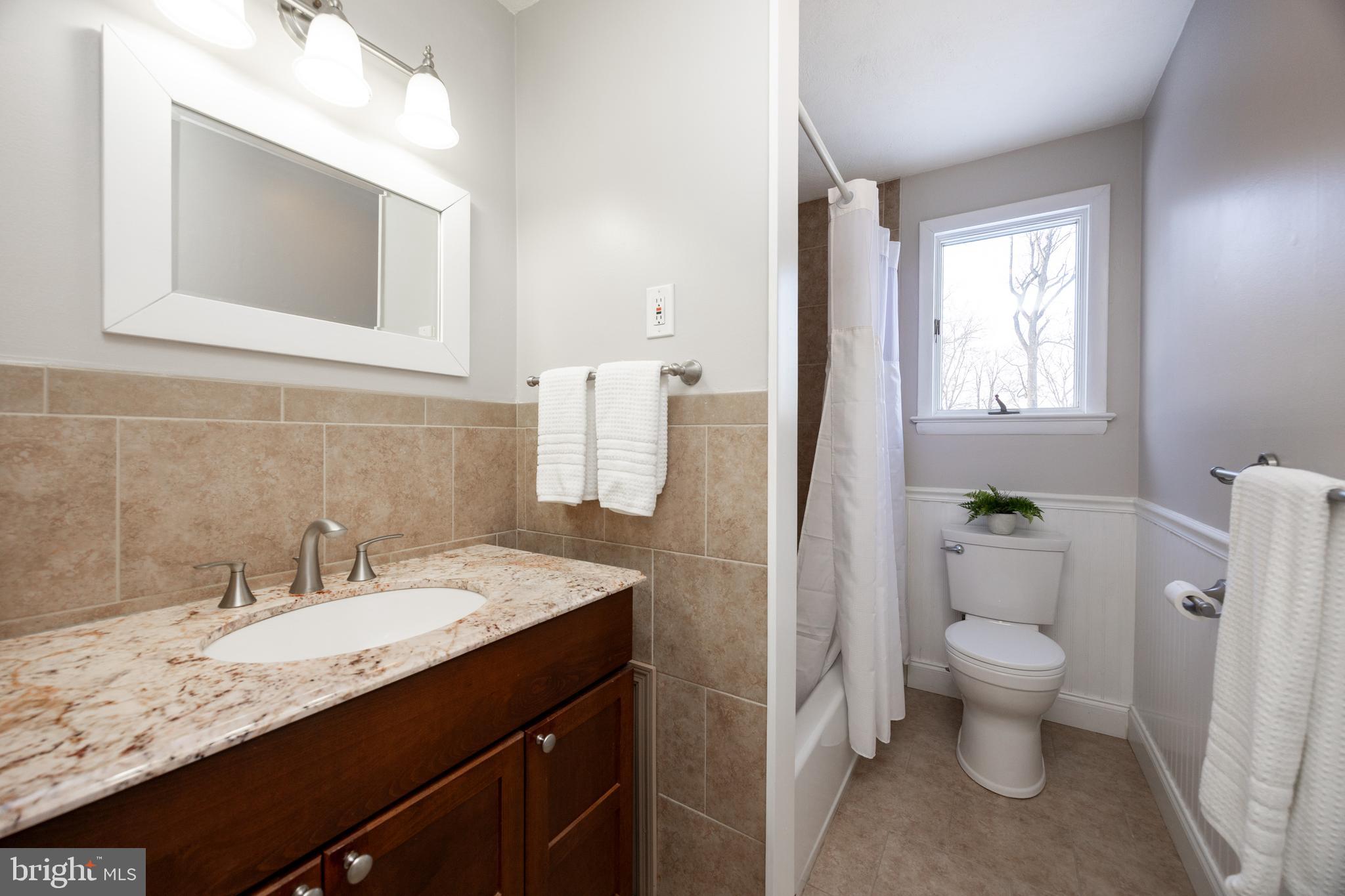 305 Concord Avenue Exton, PA 19341 - Photo 21 of 38 a bathroom with a granite countertop sink toilet and mirror
