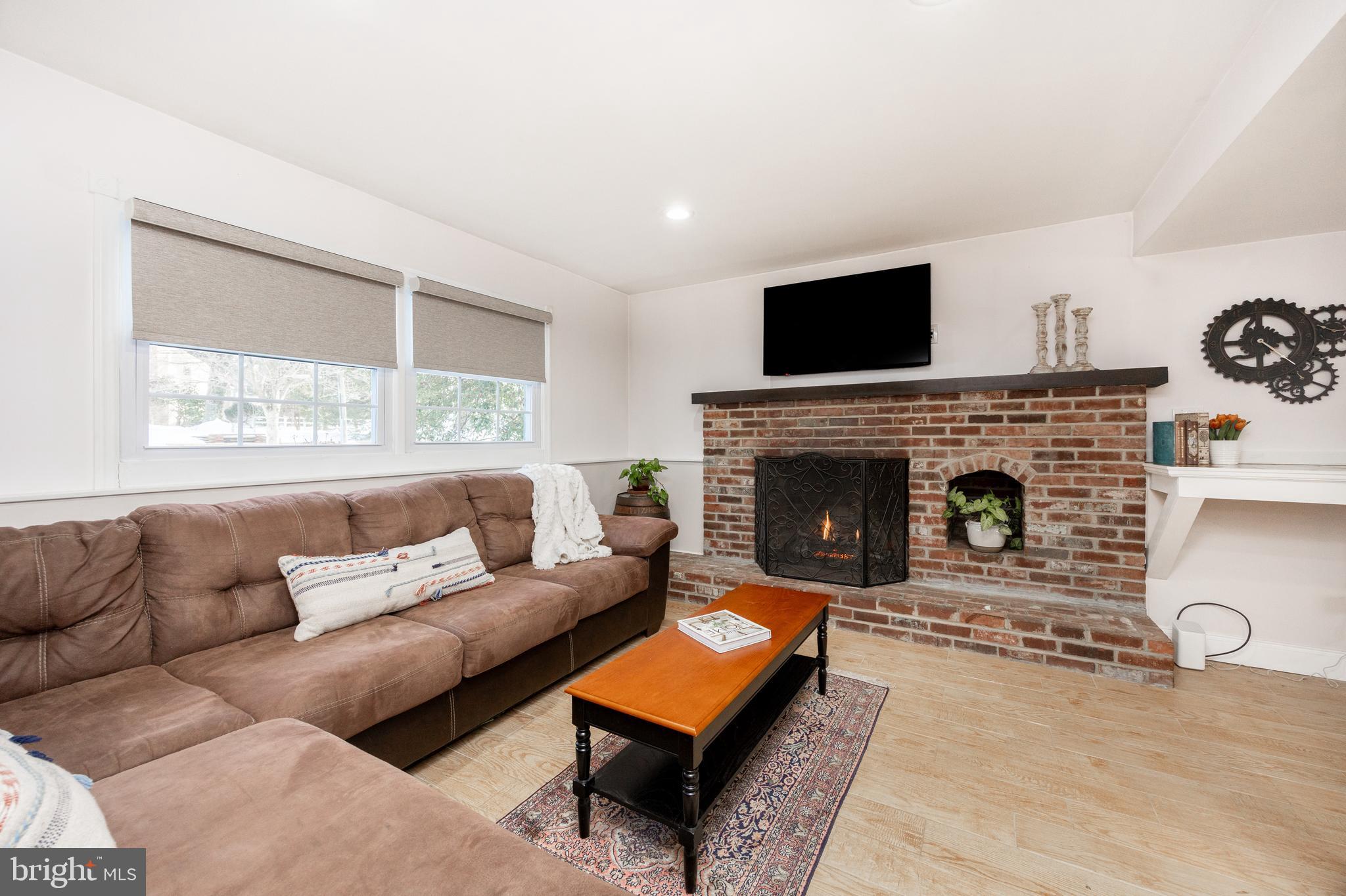 305 Concord Avenue Exton, PA 19341 - Photo 24 of 38 a living room with furniture a flat screen tv and a fireplace