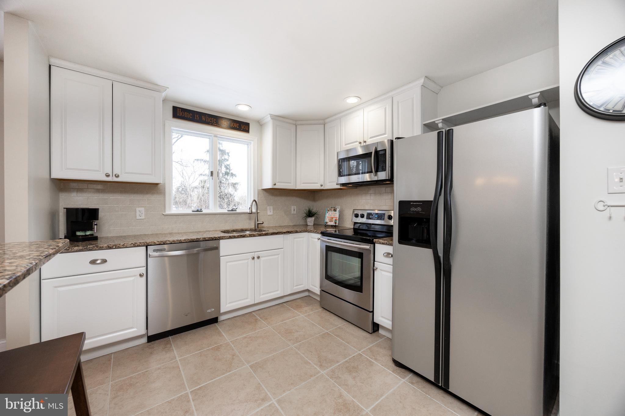 305 Concord Avenue Exton, PA 19341 - Photo 10 of 38 a kitchen with granite countertop white cabinets and stainless steel appliances