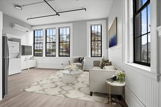 a kitchen with stainless steel appliances granite countertop a refrigerator a stove a sink dishwasher and white cabinets with wooden floor