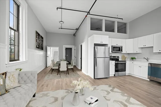a kitchen with a refrigerator cabinets and wooden floor