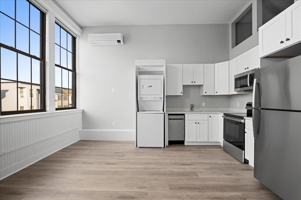 22 Waverly Street Worcester, MA 01604 - Photo 17 of 41 a kitchen with a refrigerator cabinets and wooden floor