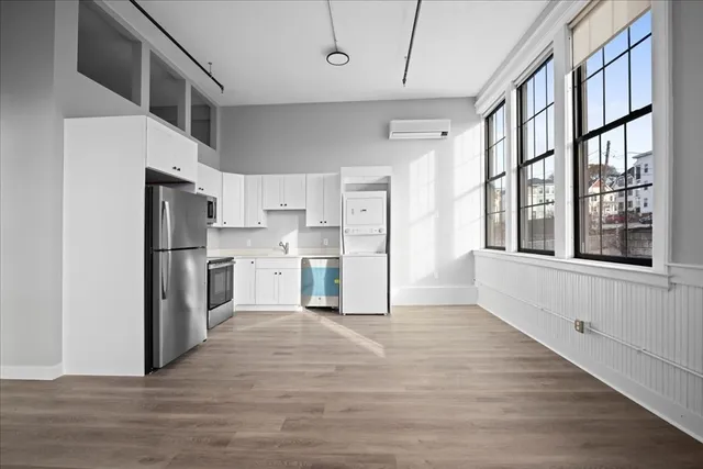 a view of kitchen with stainless steel appliances refrigerator oven and cabinets