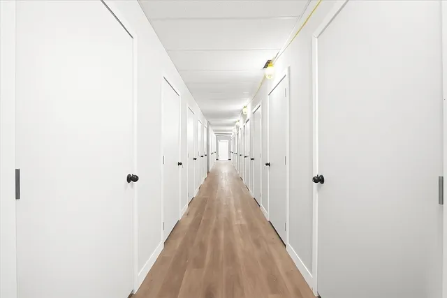 a view of staircase with white walls and windows