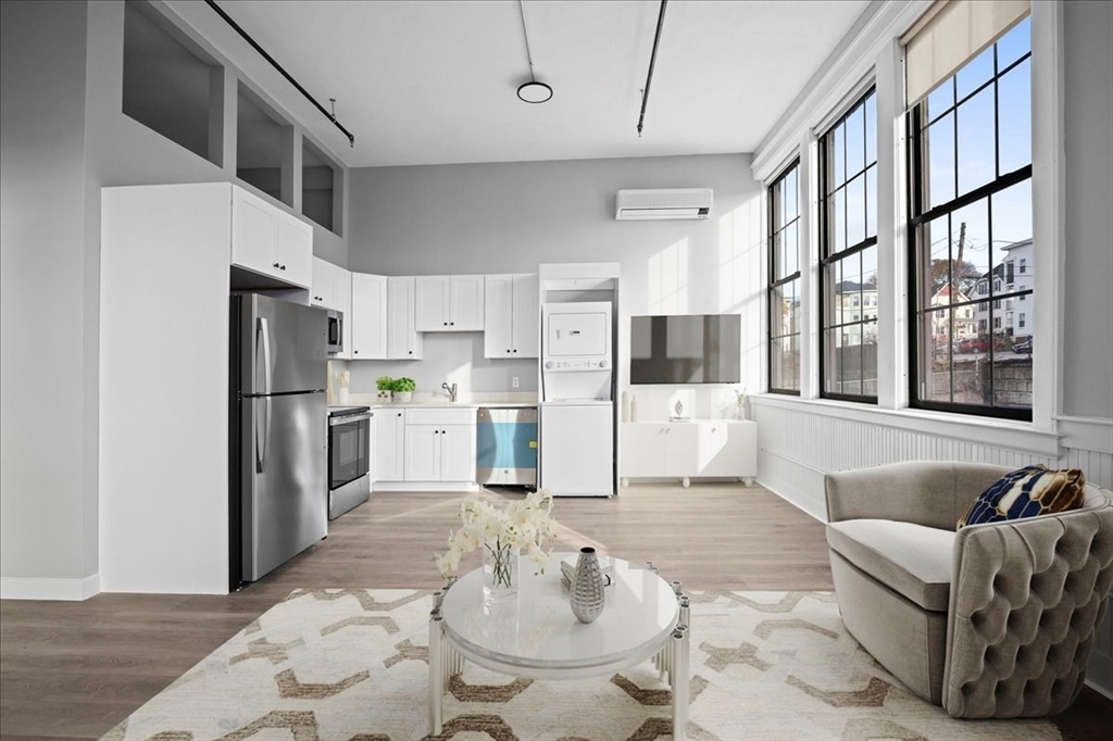 22 Waverly Street Worcester, MA 01604 - Photo 3 of 41 a living room with stainless steel appliances furniture and a kitchen view