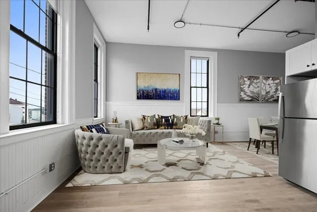 a kitchen with stainless steel appliances kitchen island granite countertop a refrigerator oven a stove top oven a sink and dishwasher