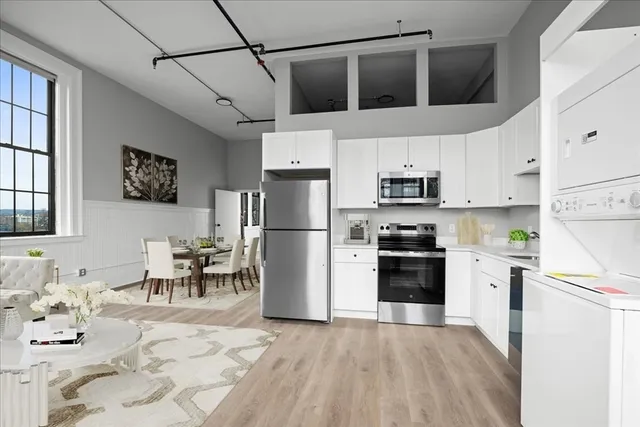 a kitchen with stainless steel appliances granite countertop a refrigerator and a stove top oven