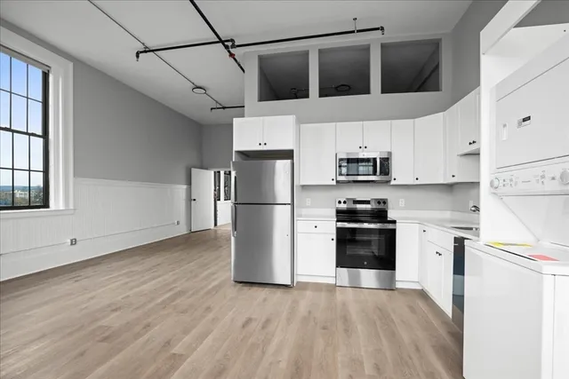 a kitchen with stainless steel appliances a refrigerator sink and cabinets